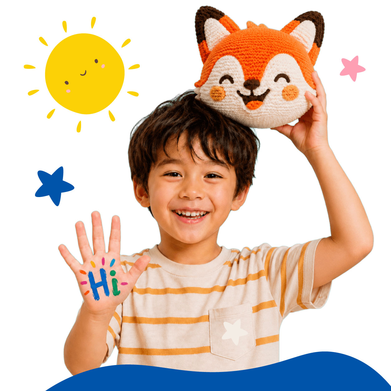 A boy waving with Hi painted on his palm, balancing a Lou the fox cushion on his head